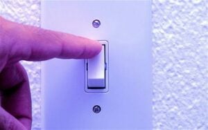 Switch on electrical wall switch for home lighting or appliances, modern design, close-up.
